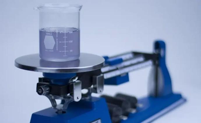 A triple beam scale weighs liquids accurately and lasts decades in the lab, making it a very low lifetime cost piece of equipment.